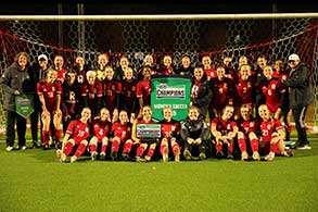 Women's soccer team player with the ball.