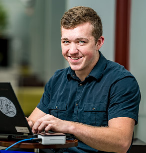 Stephen holding a drone project in the Branam Innovation Center