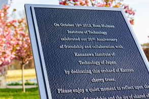 Placard with cherry trees behind