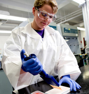 Female student prepares samples in lab.