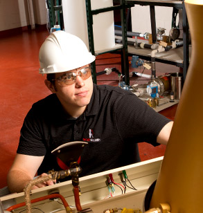 Male student works in chemical engineering lab.