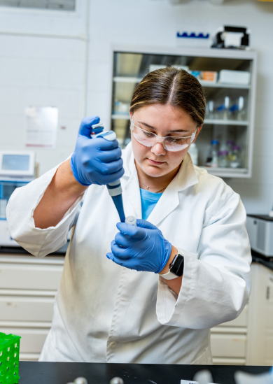 Female student prepares samples in lab.