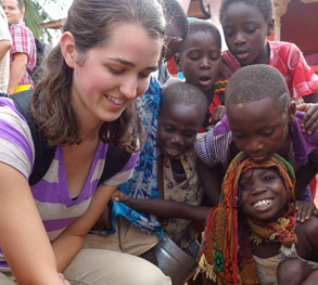 College student working with young children as part of an international program