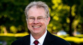 !A smiling Dr. Richard Ditteon standing outdoors on the Rose-Hulman campus