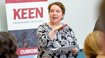 ! Image shows a  professor working with a student in a Rose-Hulman classroom.