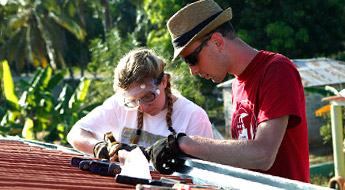 A male and female examine materials outside.