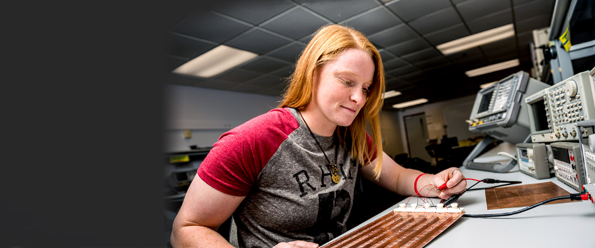 Female student works on an electrical engineering project.