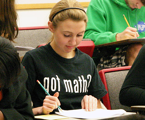 Student taking a math contest test wearing a shirt that says "Got Milk?"