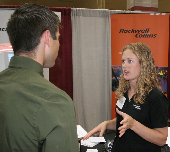 A student speaking with a recruiter at a job fair.