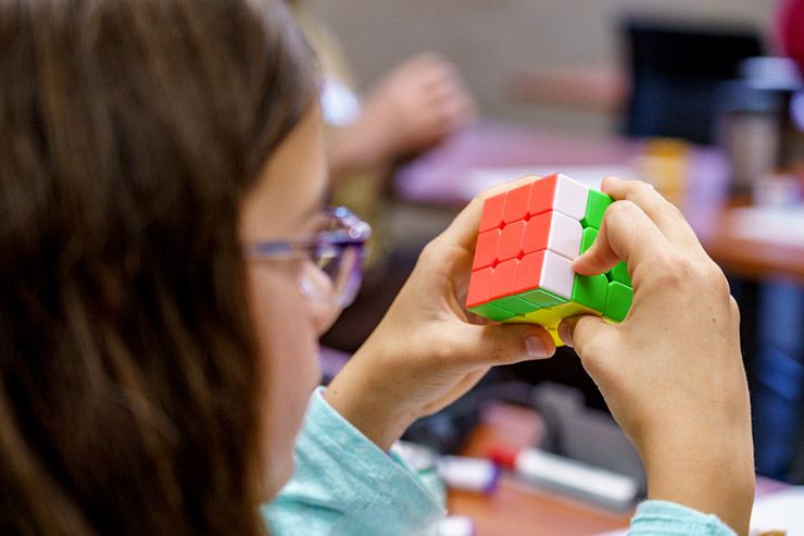 Student examines Rubik's cube
