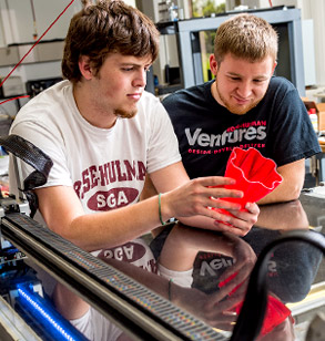 Two male students examine plastic object at Rose-Hulman Ventures.