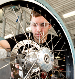 Male student examines spoked wheel.
