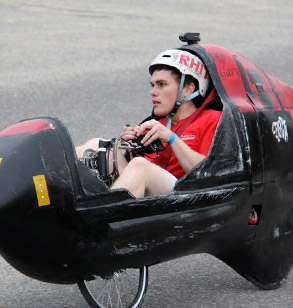 Male students pedals the human-powered vehicle.