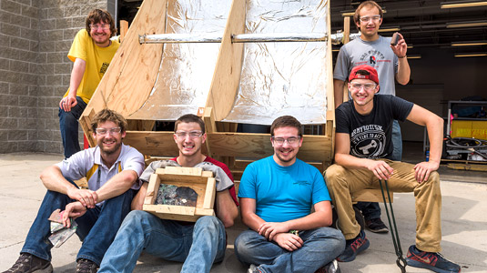 Student team poses with solar collector.