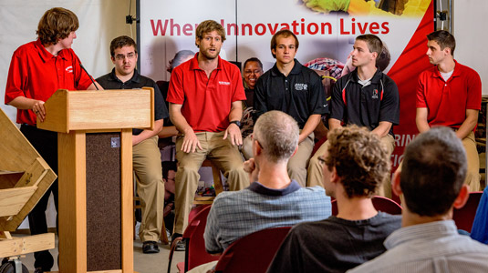 Student Grand Challenges team answers questions at open house in Branam Innovation Center.