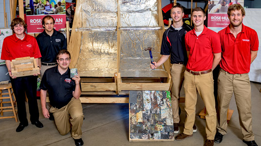 Student team poses with solar collector during media event for Grand Challenges projects.