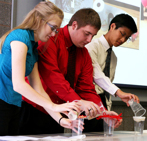 Three students demonstrate Grand Challenges-related classroom activities for K-12 teachers.