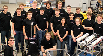 !Robotics team poses with robots.