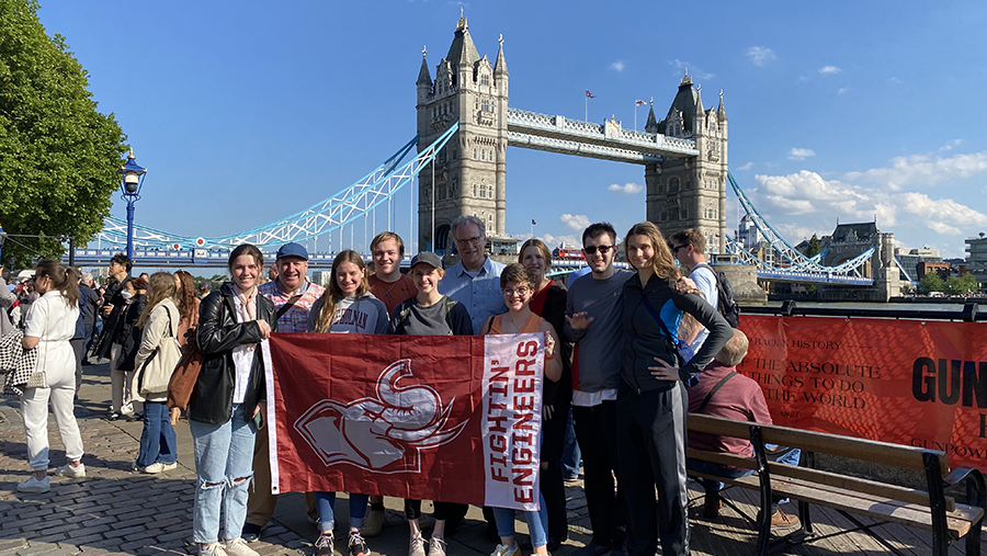 Rose-Hulman students hold school flag on trip to UK.
