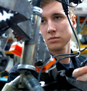 Student working on a vehicle frame