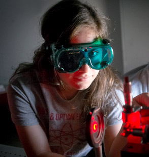 Student in optics lab with protective goggles