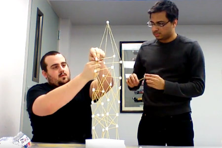 Rose-Hulman students build structure from marshmallows and spaghetti as a K-12 outreach project.