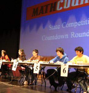 Students sitting at a table during the ' countdown round'  of the state MATHCOUNTS competition.