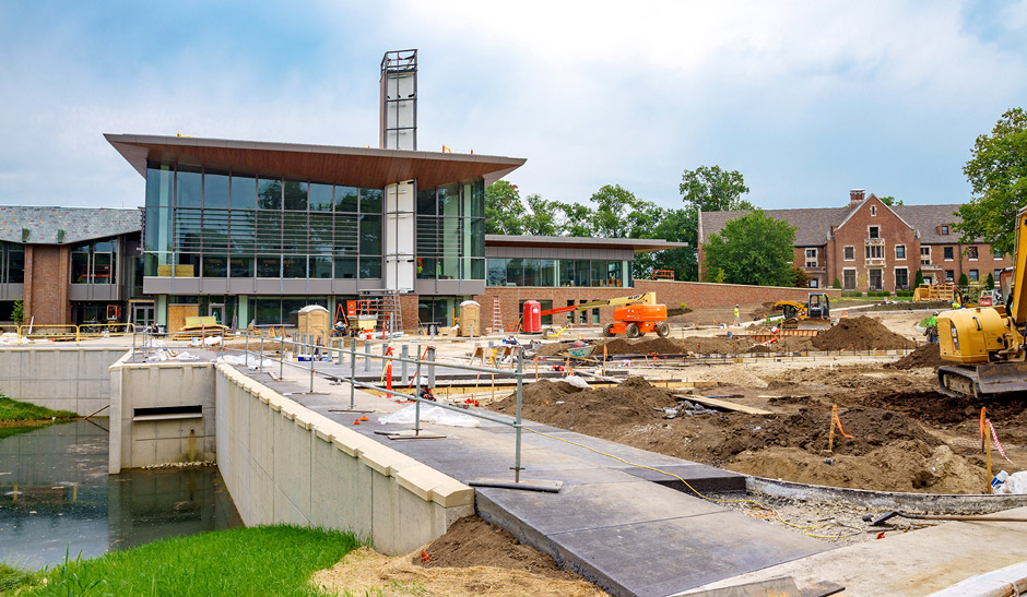 Construction area with equipment, dirt and workers.