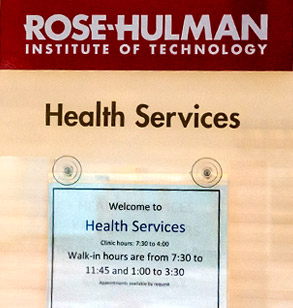 A sign on the door of the Wellness and Health Services office showing the hours of operation.