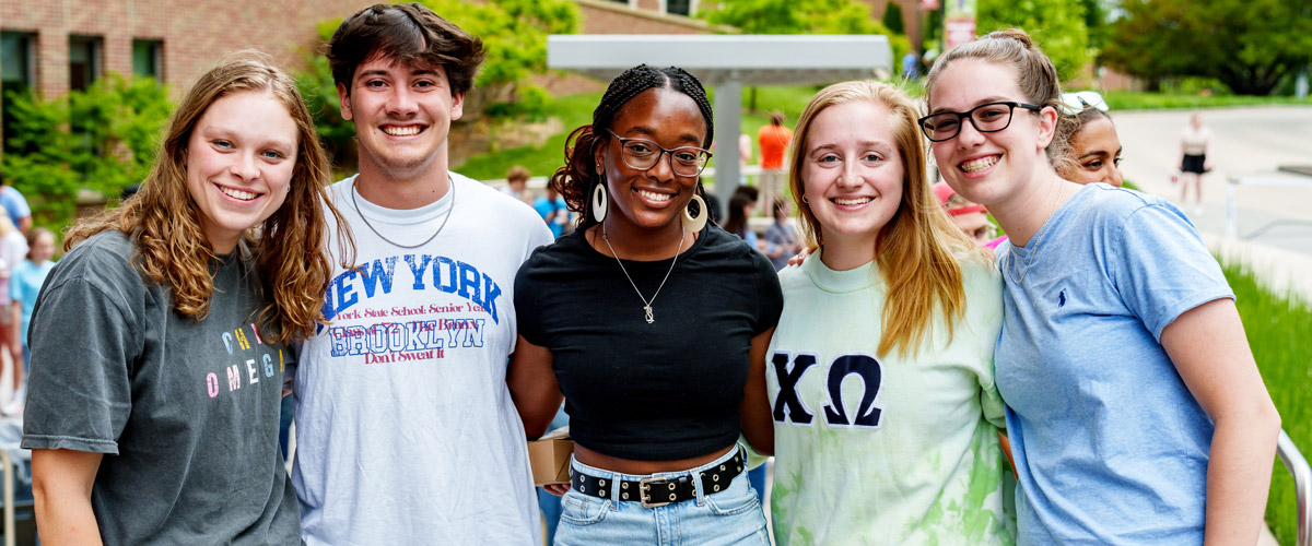Group of student enjoying time together in outside of the Mussallem Union on Final Friday events. 