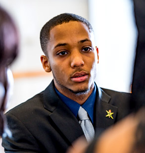 An African-American student  attending a meeting of the National Society of  Black Engineers. 