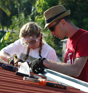 A male and female student  working on an outdoor project.