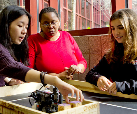 Dr. Carlotta Berry works with two students on robotics project.