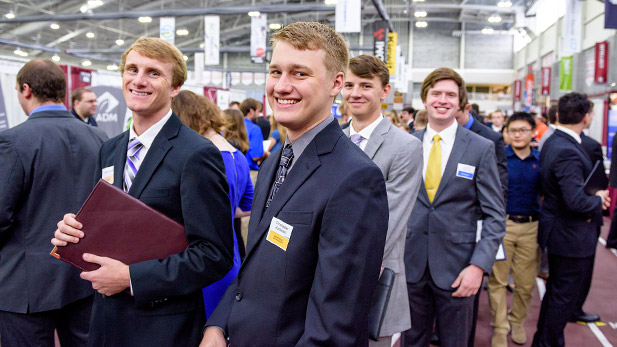 Smiling students attending the Fall Career Fair