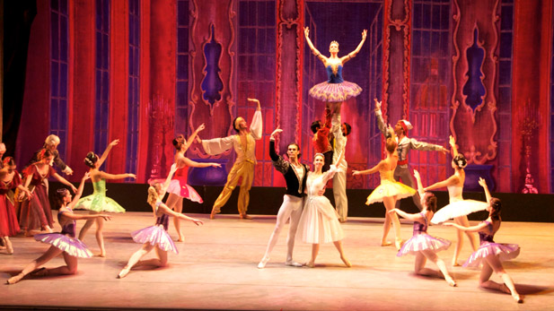 Ballet dancers in colorful costumes perform in Cinderella.