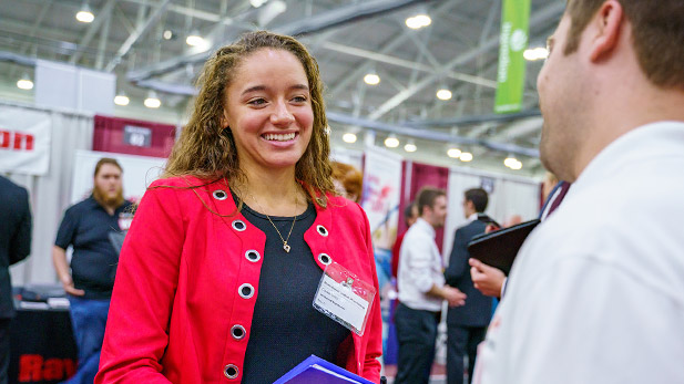 Female student talking to recruiter at career fair