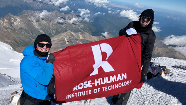 James and Matt Robinson with Rose-Hulman flag at the top of Mount Kilamanjaro
