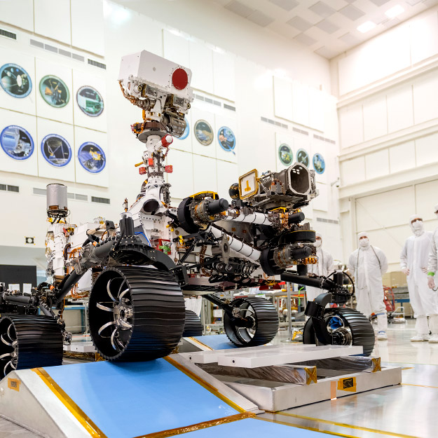 The Mars Rover is shown transposed on the Martian surface next to images of Brian Monacelli meeting with students at Rose-Hulman.