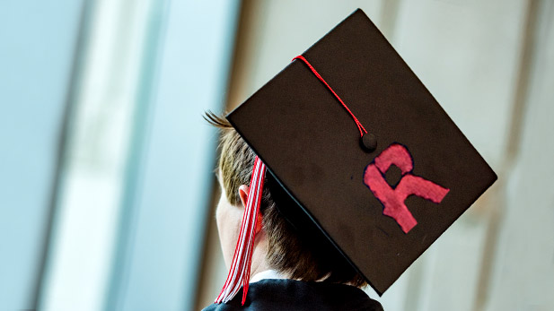Student wearing graduation cap with a Rose-Hulman R in the cap.