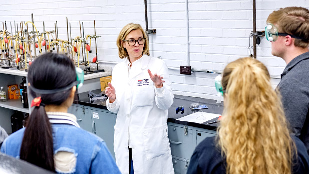 Image of Rose-Hulman Professor of Chemistry Rebecca DeVasher working with students in a lab.