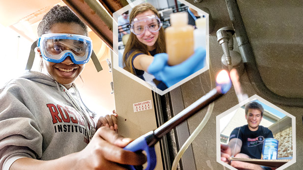 Image shows three students wearing safety goggles and smiling while working on projects.