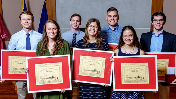 Rose-Hulman students holding their academic awards.