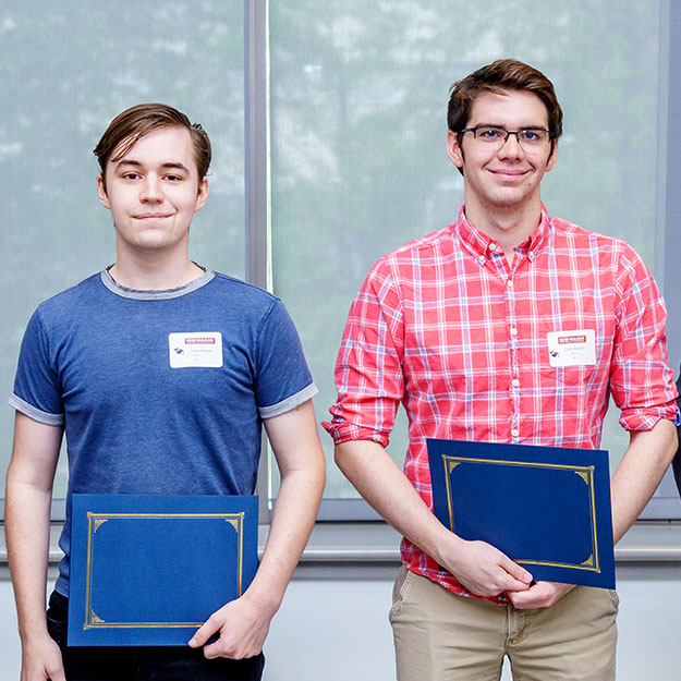 Rose-Hulman physics and optical engineering students holding awards.