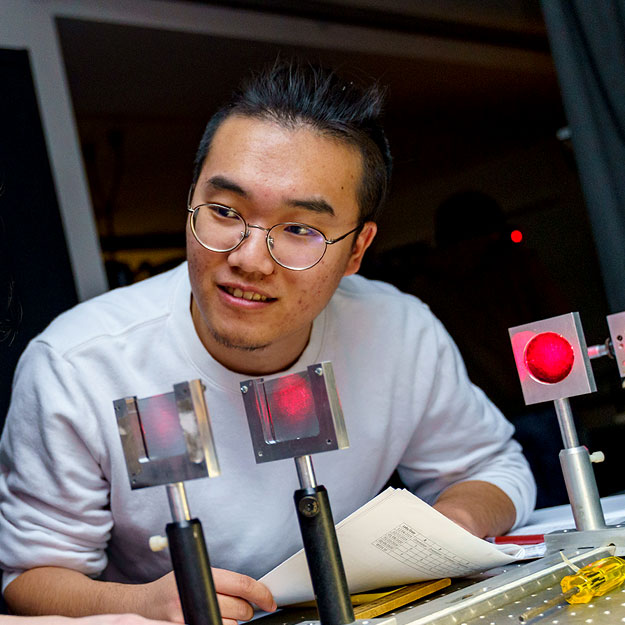 Zhaowei Chen works with optical engineering equipment at Rose-Hulman.