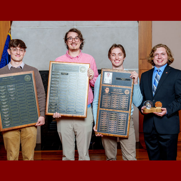 Rose-Hulman students holding awards for physics and optical engineering.