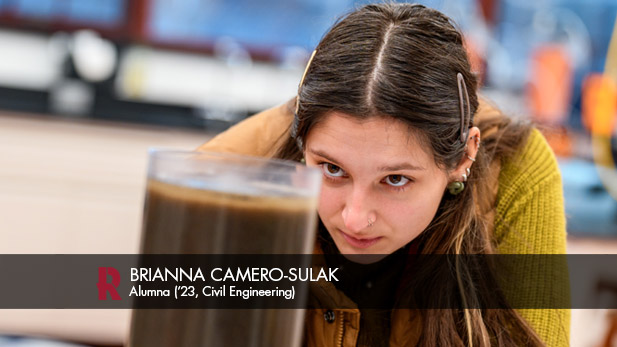 Brianna Camero-Sulak examines a container of sludge during a civil engineering lab.