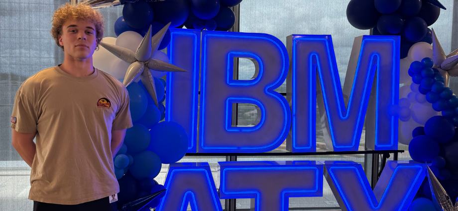 Vance Steel poses with large blue light-up IBM letters.
