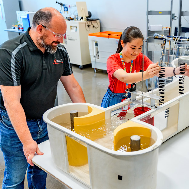 A student works alongside a faculty in multidisciplinary clean energy room.