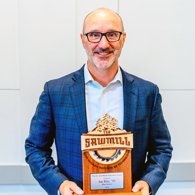 Alumnus Joe Ritz holding 2026 Tom Mason Innovation Award trophy during Sawmill Society Weekend with Tom Mason