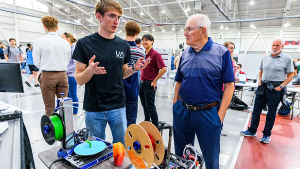 A student presents the multi-axis 3D printer at Rose Show.
